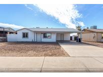Charming single-story home featuring a covered carport and low-maintenance front yard at 6817 W Palm Ln, Phoenix, AZ 85035