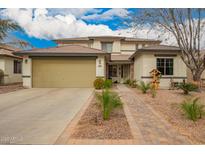 Charming two-story home with a well-manicured front yard and desert-friendly landscaping at 714 W Desert Hills Dr, San Tan Valley, AZ 85143