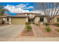 Charming two-story home featuring a well-manicured front yard and a spacious two-car garage at 714 W Desert Hills Dr, San Tan Valley, AZ 85143