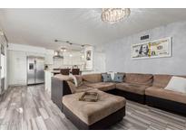 Spacious living room with a modern open floor plan and wood-look tile flooring at 7751 E Glenrosa Ave # A1, Scottsdale, AZ 85251