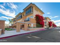 Contemporary condo building showing brick facade, stucco accents, and blooming bougainvillea at 1400 E Bethany Home Rd # 27, Phoenix, AZ 85014