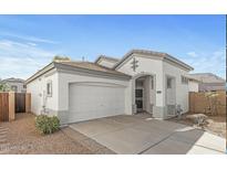 Charming single-story home with a two-car garage and inviting front entrance at 14287 W Cora Ln, Goodyear, AZ 85395