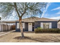 Charming single-story home with a cozy front yard, classic shutters, and covered carport at 1622 N 17Th Ave, Phoenix, AZ 85007