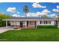 Charming single-story home featuring a well-manicured lawn and classic architectural design at 263 W 9Th S Pl, Mesa, AZ 85201