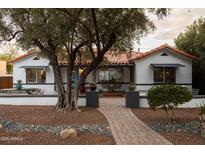 Charming single-story home with a brick pathway, red tile roof, and lush landscaping at 45 W Edgemont Ave, Phoenix, AZ 85003