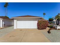 Attached garage with a multi-car driveway and mature landscaping at 602 W Grandview Rd, Phoenix, AZ 85023