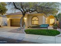 Charming single-story home featuring desert landscaping, a tiled roof, and a cozy front bench at 11919 E Del Timbre Dr, Scottsdale, AZ 85259