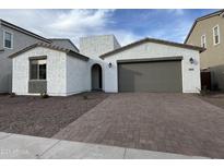 Charming single Gathering home featuring a two-car garage and low maintenance landscaping at 18032 W Vogel Ave, Goodyear, AZ 85338