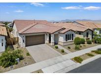 Stunning single-story home with tile roof, desert landscaping, and a spacious two-car garage at 20886 E Sparrow Dr, Queen Creek, AZ 85142