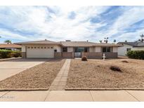 Charming single-story home with a two-car garage and beautiful desert landscaping at 2421 E Del Rio Dr, Tempe, AZ 85282