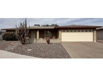 Charming brick home featuring a well-manicured desert landscape and a spacious two-car garage at 4026 E Catalina Cir, Mesa, AZ 85206