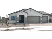 Charming single-story home featuring a tile roof, two-car garage, and low-maintenance desert landscaping at 43527 N Wollemi St, Queen Creek, AZ 85140
