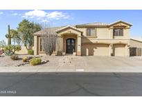 Charming two-story home with desert landscaping, three-car garage, and a welcoming front entrance at 4534 E Oberlin Way, Cave Creek, AZ 85331