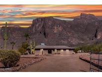 Single story home featuring desert landscaping, mature cacti, mountain views and a gated entrance at 5962 E Siesta St, Apache Junction, AZ 85119