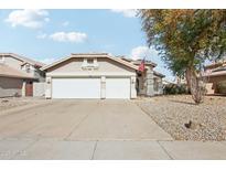 Charming single-story home with a spacious two-car garage and well-maintained desert landscaping at 698 W Merrill Ave, Gilbert, AZ 85233