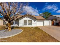 Charming single-story home featuring a well-manicured lawn and an attached two-car garage at 7326 W Georgia Ave, Glendale, AZ 85303