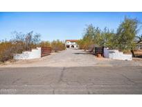 Gated driveway leading to beautiful estate with mature desert landscaping in a rural setting at 7650 E Culver St, Mesa, AZ 85207