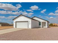 Charming single Gathering home with attached two car garage and neutral colored stucco at 9504 W Century Dr, Arizona City, AZ 85123