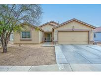 Attractive single-Gathering home featuring a two-car garage, neutral stucco, and low-maintenance desert landscaping at 12425 N 127Th Dr, El Mirage, AZ 85335