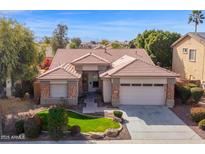 Charming single-story home boasts a well-manicured front yard and attached two-car garage in a residential neighborhood at 12607 W Highland Ave, Litchfield Park, AZ 85340