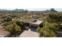 Stunning single-story home featuring a concrete driveway and desert landscaping in a serene neighborhood at 1301 Coyote Pass, Carefree, AZ 85377