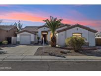 Inviting single-story home with a charming desert landscape and spacious driveway at 1653 W Morelos St, Chandler, AZ 85224