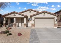 Charming single-story home with stucco exterior, tile roof, and a well-maintained desert landscape at 17286 W Morning Glory St, Goodyear, AZ 85338