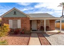 Charming brick home with a cozy front porch and well-maintained landscaping under a bright blue sky at 2315 N 12Th St, Phoenix, AZ 85006