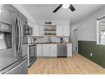 Bright kitchen with stainless steel appliances, white cabinets, and butcher block countertops at 248 S 95Th Pl, Chandler, AZ 85224