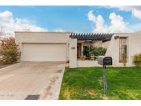 Charming single-story home with a well-maintained lawn, front patio, and two car garage at 2509 N 61St Way, Scottsdale, AZ 85257