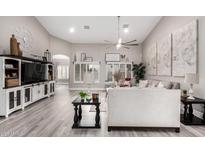 Inviting living room with shuttered windows, neutral decor, and a cozy atmosphere, ideal for relaxation at 30427 W Vale Dr, Buckeye, AZ 85396