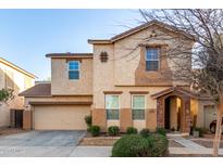 Charming two-story home featuring a stucco exterior, a two-car garage, and a covered front entry at 4225 E Carla Vista Dr, Gilbert, AZ 85295
