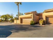 Inviting home exterior featuring a desert landscape, garage, and private entrance at 4434 E Camelback Rd # 128, Phoenix, AZ 85018