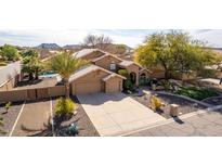 Stunning home featuring a tile roof, three-car garage, manicured landscaping, and circular driveway at 4937 W Desert Hollow Dr, Phoenix, AZ 85083