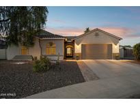 Charming home exterior features a two-car garage, beautiful landscaping, and a welcoming entrance at 5225 S Opal Pl, Chandler, AZ 85249