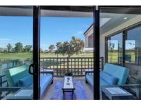 Relaxing patio features comfortable seating and a view of the lush golf course and pristine pond at 7272 E Gainey Ranch Rd # 27, Scottsdale, AZ 85258