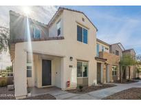 Modern two-story home features a neutral stucco exterior, a welcoming front entrance and low-maintenance landscaping at 778 E Harper St # 101, Gilbert, AZ 85297