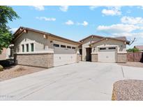 Inviting single-story home with a three-car garage and a well-maintained yard in a sunny neighborhood at 10630 W Pinchot Ave, Avondale, AZ 85392