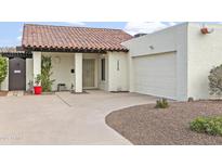 Charming front exterior view of a home with a red tile roof, white stucco walls, and a well-manicured yard at 1216 E Rancho Dr, Phoenix, AZ 85014