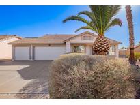 Charming single-story home featuring a three car garage and mature desert landscaping at 1227 W 12Th Ave, Apache Junction, AZ 85120