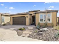 Inviting single-story home showcasing desert landscaping, a stone walkway, and an attached two-car garage at 175 E Santa Lucia Ln, Queen Creek, AZ 85140