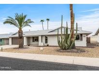 Charming single-story home featuring a well-maintained yard with desert landscaping and a spacious two-car garage at 20210 N 124Th Dr, Sun City West, AZ 85375