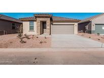 Charming single-story home featuring a stone entrance and a two-car garage with desert landscaping at 20660 N Confetti Ct, Maricopa, AZ 85138