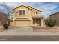 Charming two-story home with tan stucco, well-maintained landscaping, and a welcoming front entrance at 2558 W Jasper Ave, Apache Junction, AZ 85120