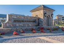 Stone community sign reading 'Atrium at Somerset' with manicured flowerbeds and rock landscaping at 2779 E Derringer Way, Gilbert, AZ 85295