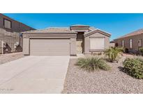 Charming single-story home featuring a two-car garage and low-maintenance desert landscaping at 320 W Phantom Dr, Casa Grande, AZ 85122