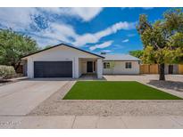 Charming single-story home with a manicured lawn and a two-car garage at 4215 W Villa Rita Dr, Glendale, AZ 85308