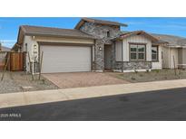 Charming home featuring a brick driveway, stone accents, and a two-car garage at 44717 N 44Th Dr, Phoenix, AZ 85087