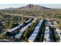 Stunning aerial view of the apartment complex with scenic mountain backdrop at 6125 E Indian School Rd # 216, Scottsdale, AZ 85251