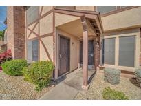 Inviting front entrance with covered entryway and secure doors surrounded by tidy desert landscaping at 7905 W Thunderbird Rd # 308, Peoria, AZ 85381